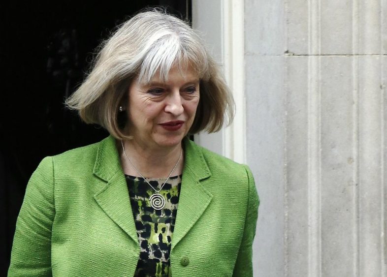 Britain's Home Secretary Theresa May leaves Downing Street in London July 8, 2014. REUTERS/Luke MacGregor (BRITAIN - Tags: POLITICS) - RTR3XLEG