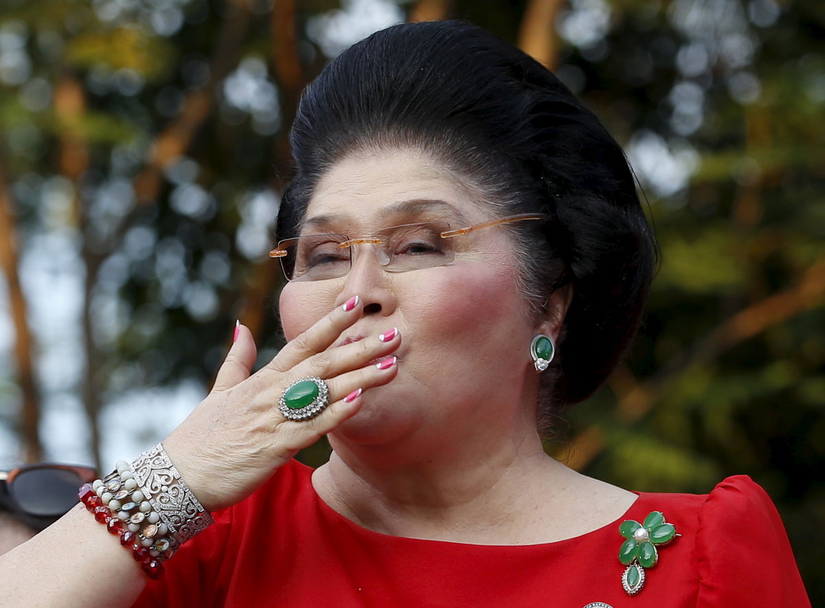 Former Philippine first lady Imelda Marcos blows a kiss to supporters after her son Senator Ferdinand Marcos Jr announced his Vice-Presidential bid during a political rally in Manila