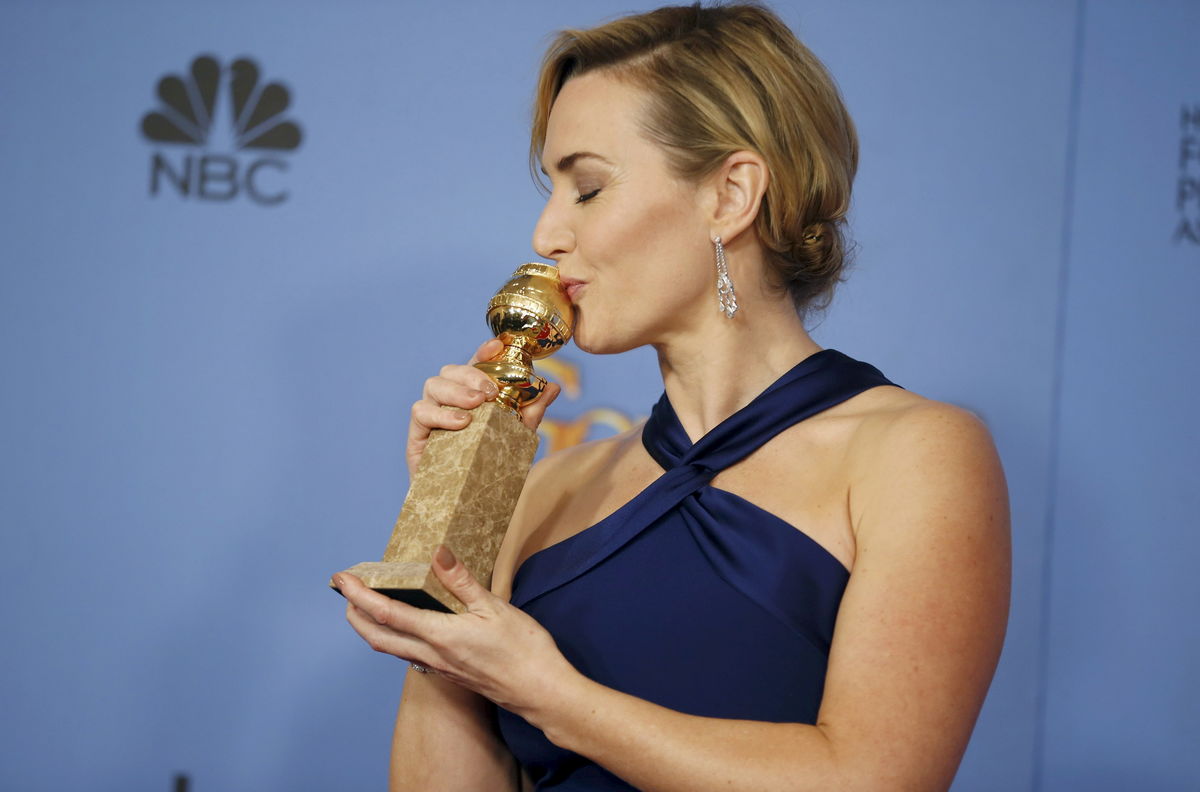 Actress Kate Winslet poses with her award for Best Performance by an Actress in a Supporting Role in any Motion Picture for her role in “Steve Jobs” at the 73rd Golden Globe Awards in Beverly Hills