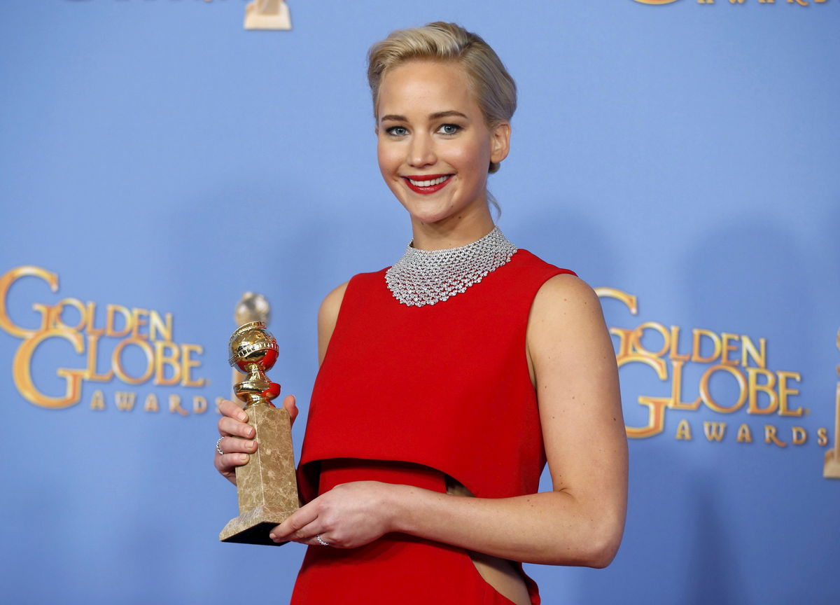 Jennifer Lawrence poses backstage with the award for Best Performance by an Actress in a Motion Picture - Musical or Comedy for her role in 