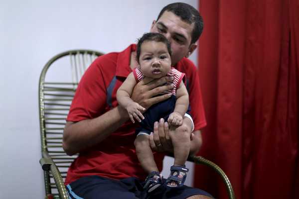 Glecion Fernando holds 2 month old son Guilherme Soares Amorim, who was born with microcephaly, near at her house in Ipojuca
