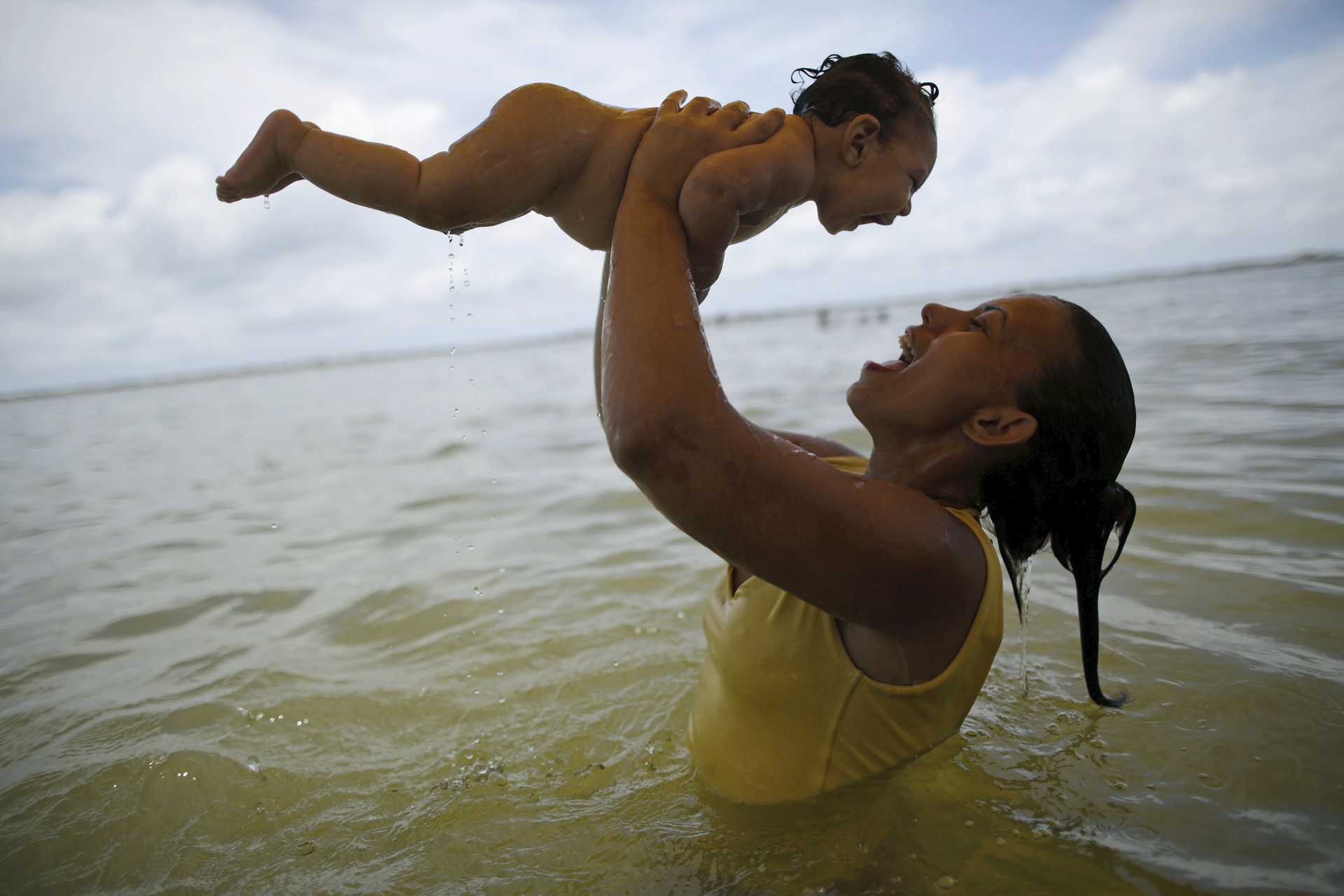 Alves holds her daughter in Olinda