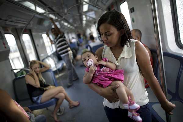 Luana Vieira, 4 months, who was born with microcephaly, is held by her mother Rosana Vieira Alves as they ride the subway after a doctor’s appointment in Recife