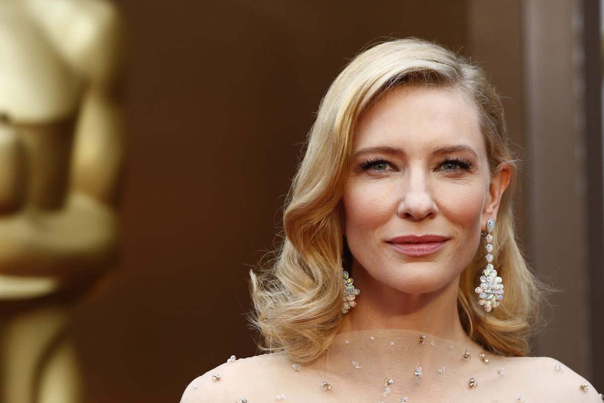 Cate Blanchett, best actress nominee for her role in “Blue Jasmine” wears a nude Armani gown with metallic embellishments as she poses at the 86th Academy Awards in Hollywood, California