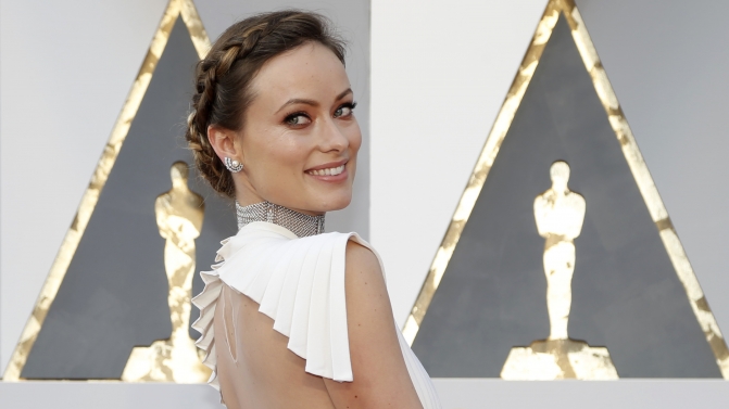 Actress Olivia Wilde poses as she arrives at the 88th Academy Awards in Hollywood