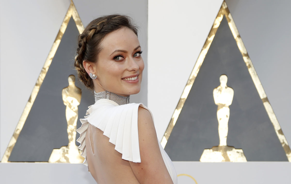 Actress Olivia Wilde poses as she arrives at the 88th Academy Awards in Hollywood