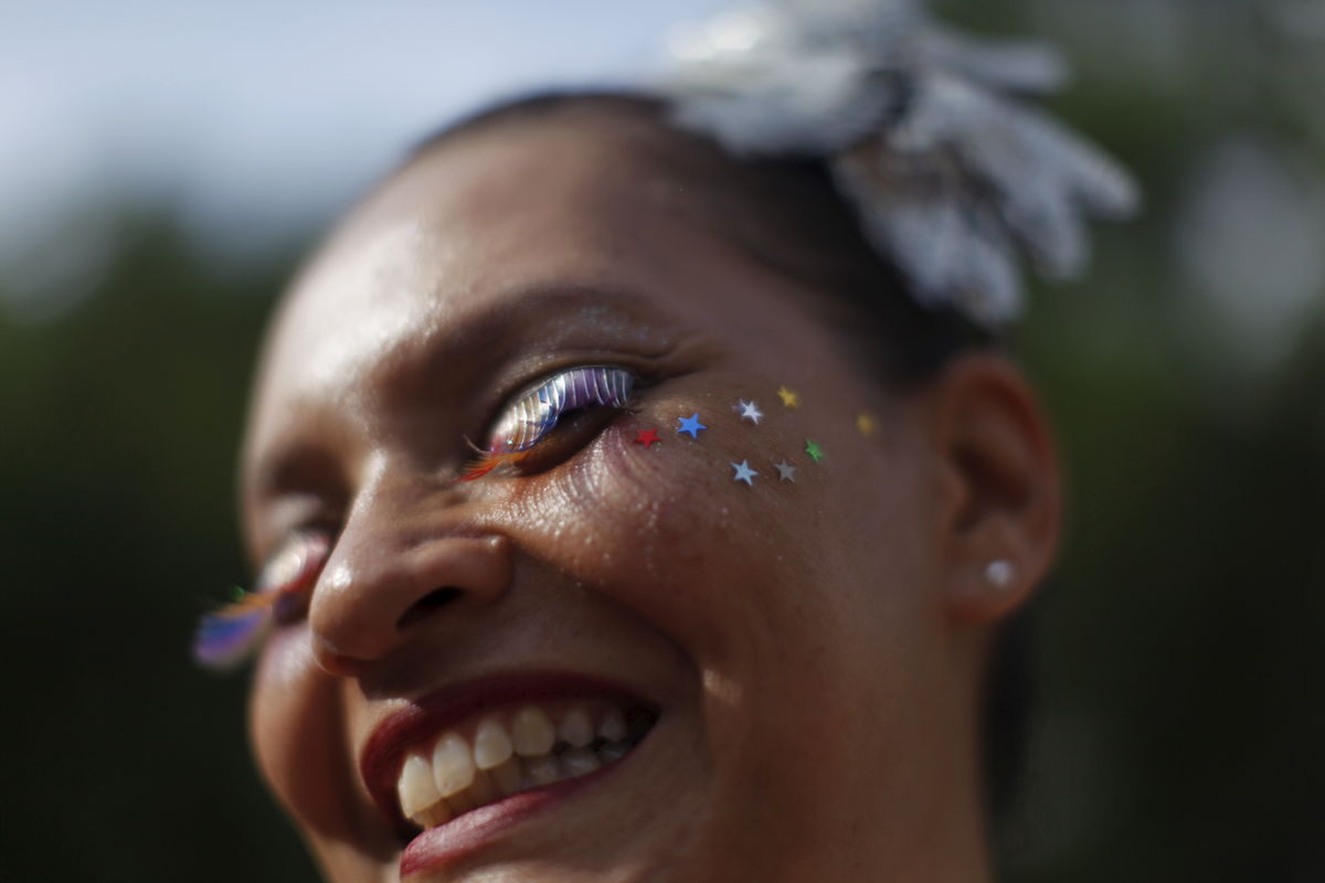 A reveller takes part in an annual block party known as “Cordao de Prata Preta”, one of the many carnival parties to take place in the neighbourhoods of Rio de Janeiro