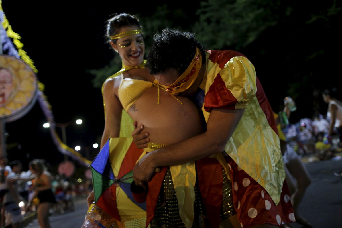Henrique kisses his wife Paula, who is seven months pregnant, during an annual block party known as “Eu Acho e pouco” (I think it is little) one of the many carnival parties to take place in the neighbourhoods of Olinda