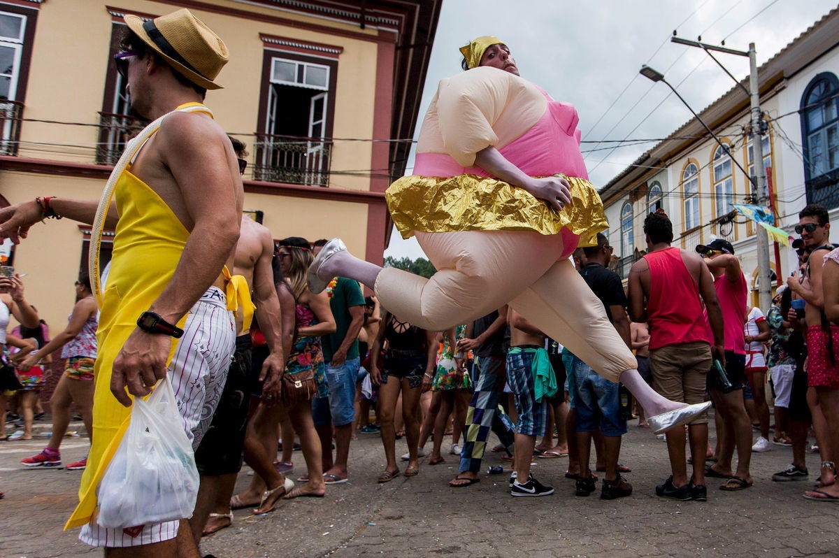 Revellers participate during an annual block party in Sao Luiz do Paraitinga