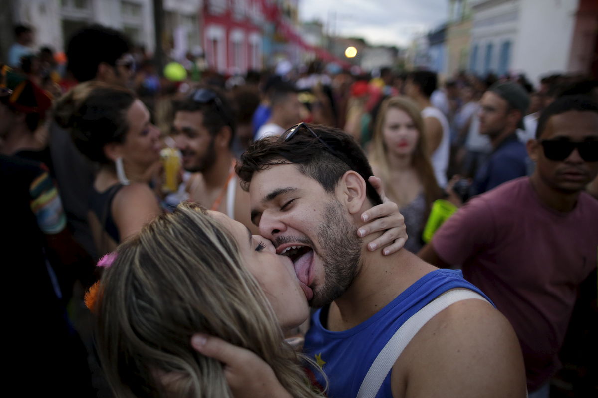 Revellers kiss during a carnival party in a neighborhood in Olinda