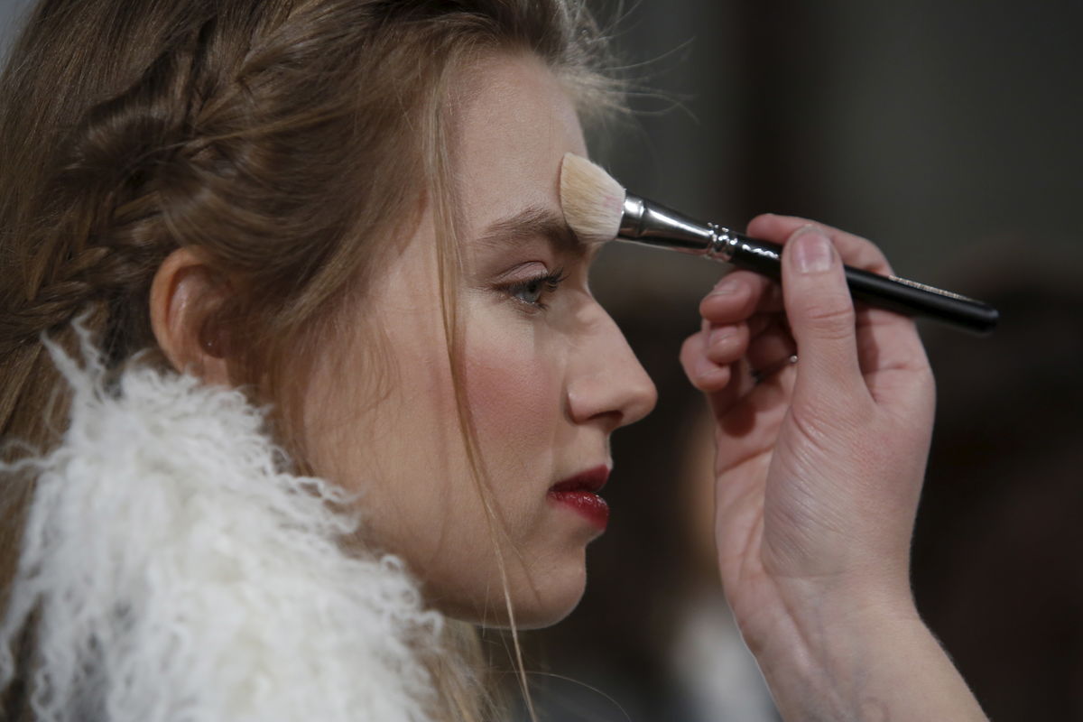A model is prepared before presenting the Rachel Zoe Fall/Winter 2016 collection at New York Fashion Week