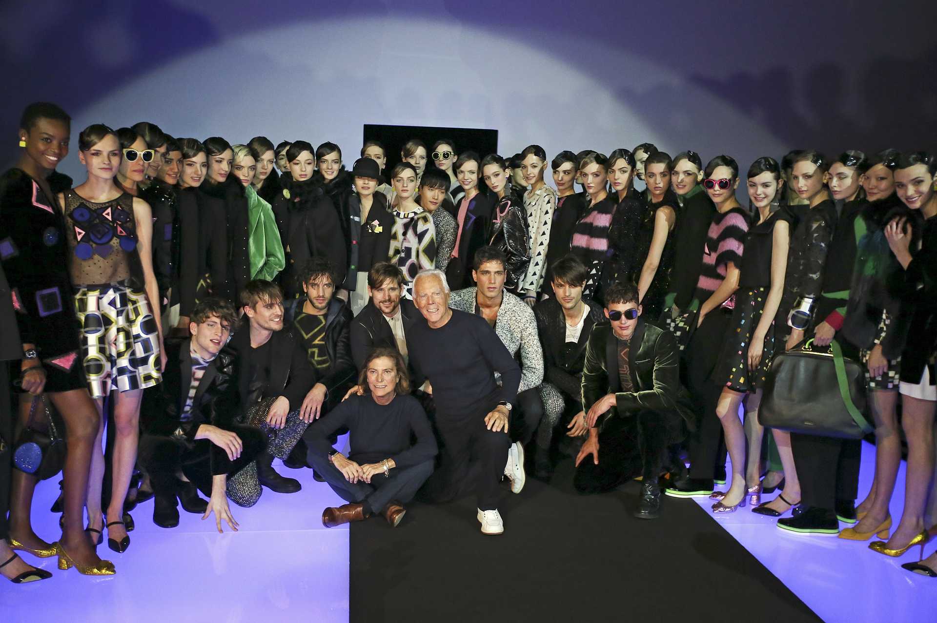 Italian designer Armani pose with his models at the end of the Emporio Armani Autumn/Winter 2016 women’s collection during Milan Fashion Week
