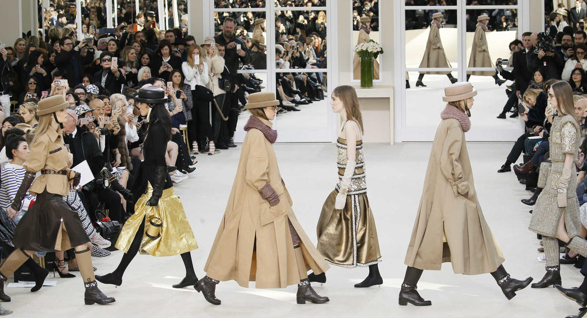 Models present creations by German designer Karl Lagerfeld as part of his Fall/Winter 2016/2017 women’s ready-to-wear collection for fashion house Chanel in Paris