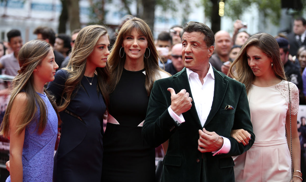 Cast member Sylvester Stallone poses for a photograph with his wife and daughters as they arrive for the world premiere of the film “The Expendables 3” at Leicester Square in London