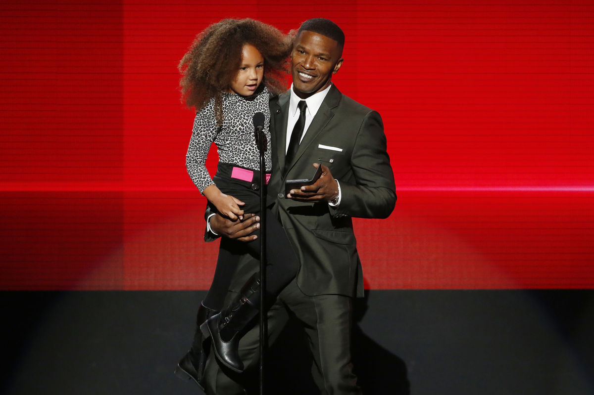 Actor Jaime Foxx presents the award for favorite rap/hip hop album with his daughter Annalise during the 42nd American Music Awards in Los Angeles