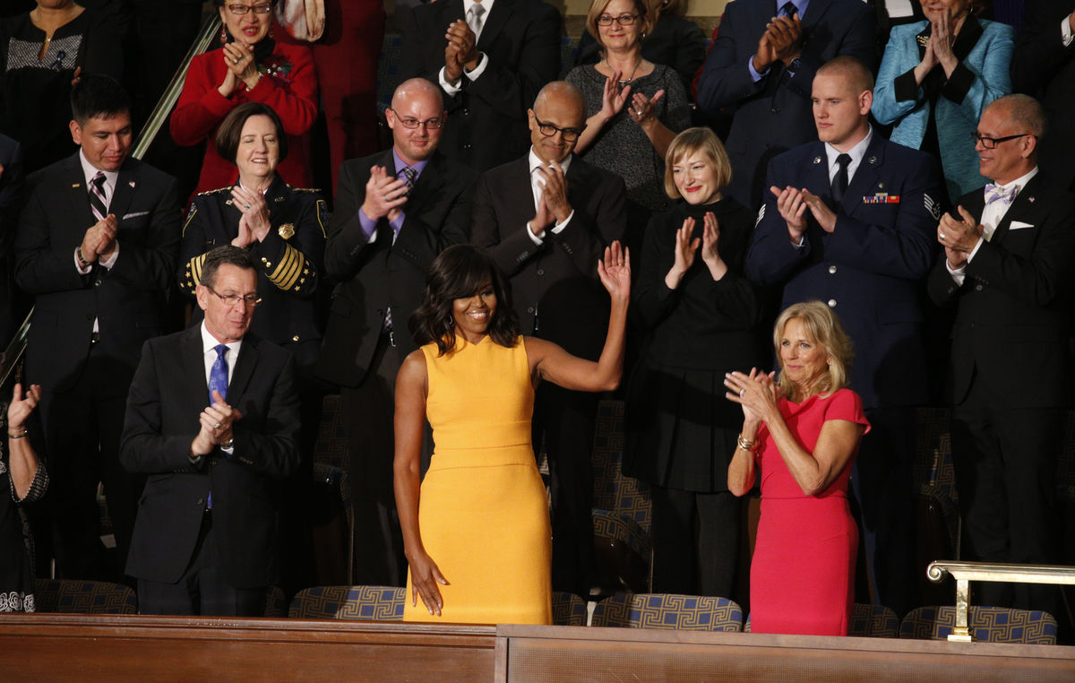 U.S. first lady Michelle Obama waves from her box in the gallery while attending U.S. President Barack Obama’s State of the Union address to a joint session of Congress in Washington