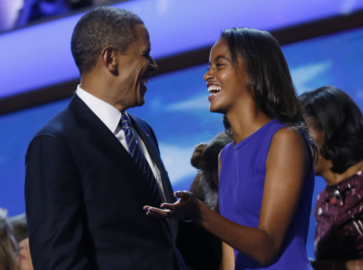 U.S. President Barack Obama and his daughter Malia wave at the conclusion of the final session of the Democratic National Convention in Charlotte