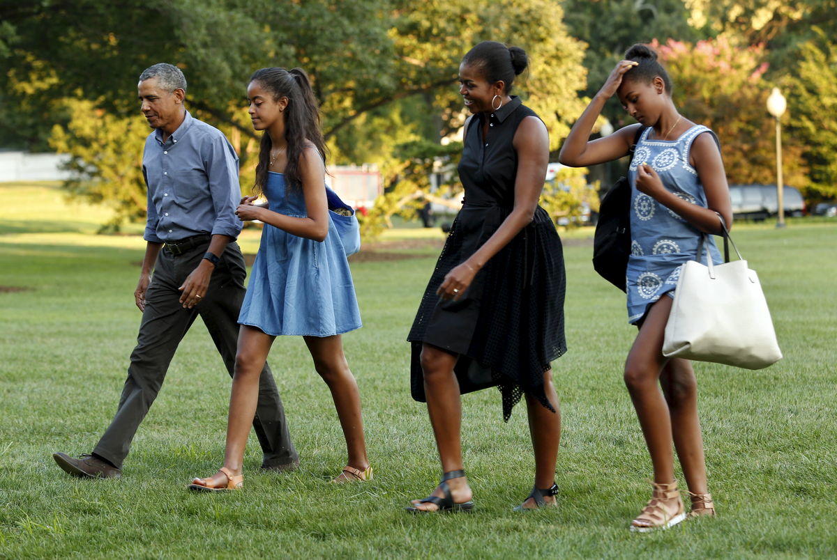 U.S. President Barack Obama walks with First lady Michelle Obama and their daugthers Malia and Sasha on the South Lawn of the White House upon their return to Washington following a two-week vacation on Martha’s Vineyard in Massachusetts