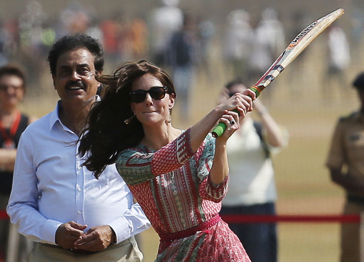 Britain’s Catherine, Duchess of Cambridge, plays cricket with children at a ground in Mumbai, India