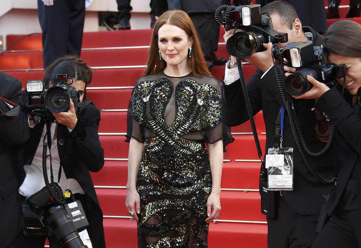 Actress Julianne Moore poses on the red carpet as she arrives for the opening ceremony and the screening of the film “Cafe Society” out of competition during the 69th Cannes Film Festival in Cannes