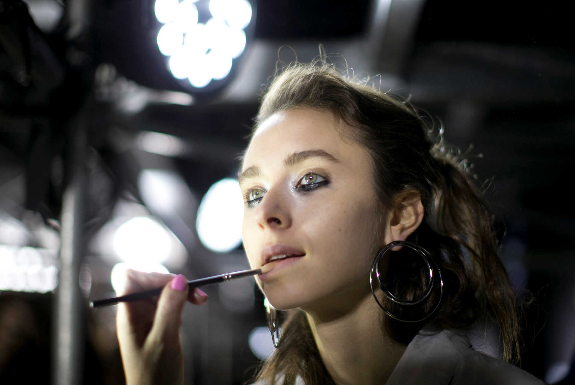 A model has makeup applied backstage before the Manning Cartell catwalk show at Australian Fashion week under the Sydney Harbour Bridge