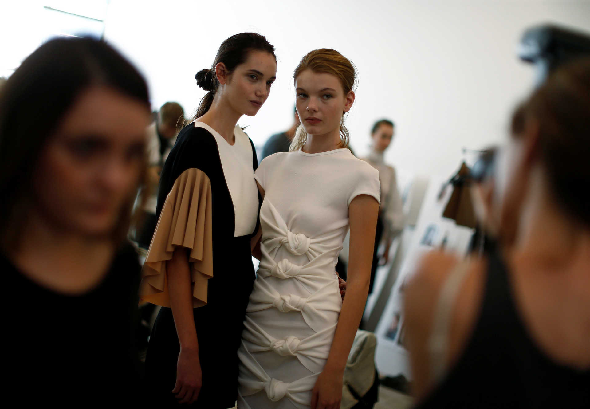 Models pose for a photographer’s picture backstage before the Christopher Esber show at Australian Fashion week in Sydney