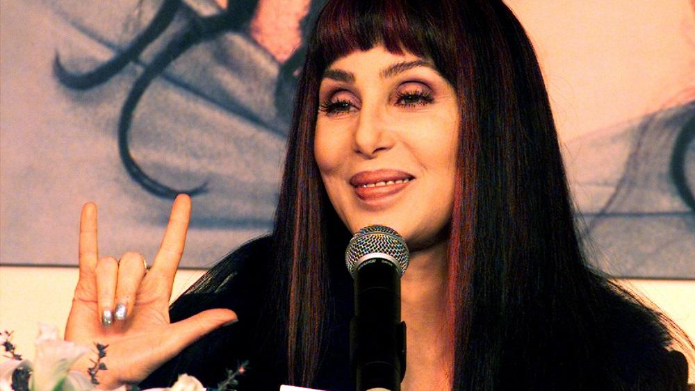 CHER MAKES LOVE SIGN IN MADRID.
