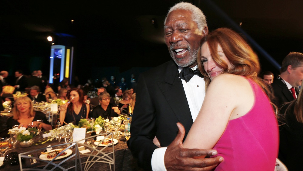 Actors Morgan Freeman and Julia Roberts hug during a commercial break at the 20th annual Screen Actors Guild Awards in Los Angeles