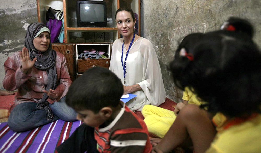 UNHCR Goodwill Ambassador Angelina Jolie interacts with an Iraqi refugee family living in Jaramana