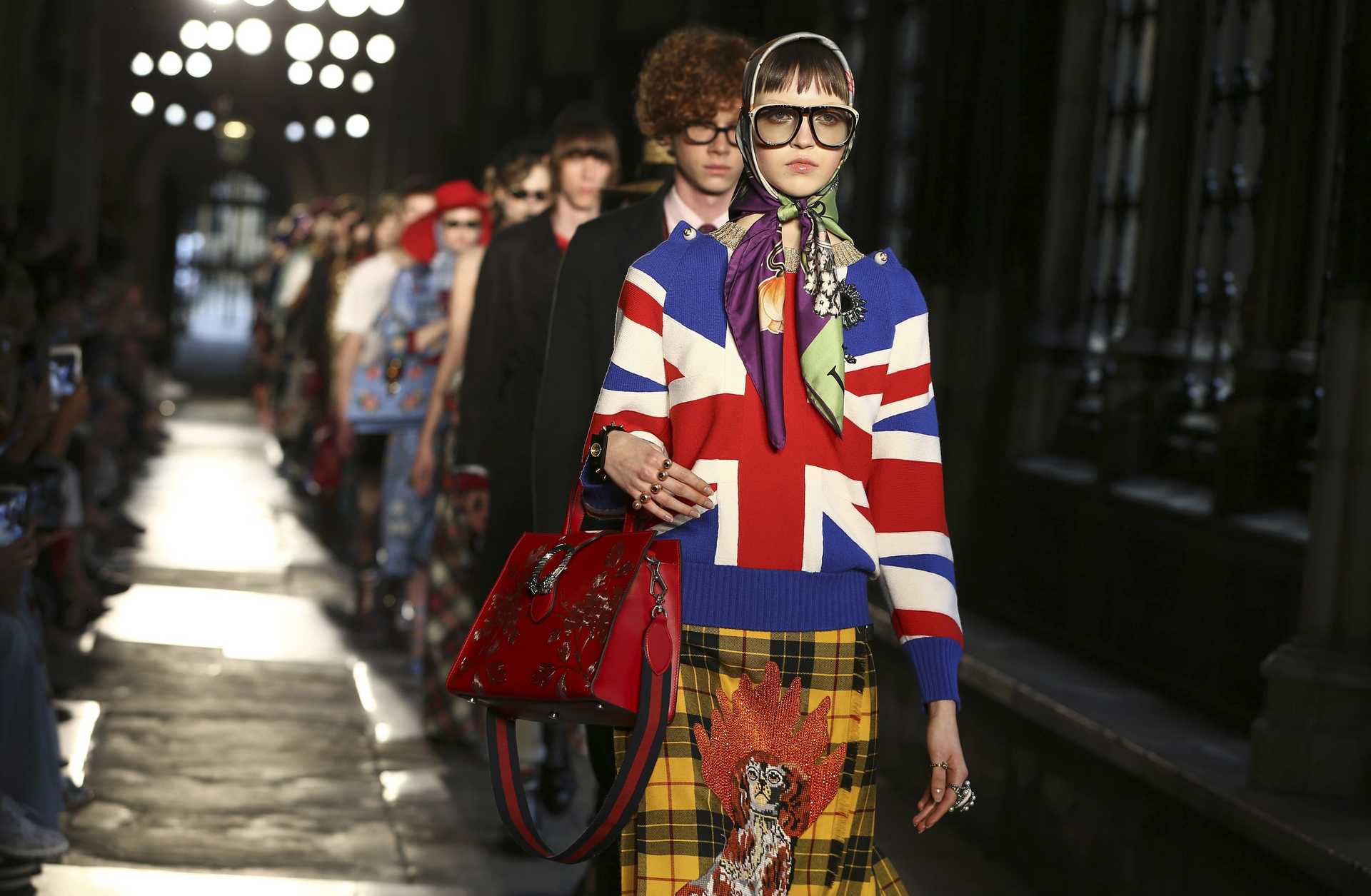 Models presents creations by Gucci at a catwalk show in the cloisters of Westminster Abbey in London