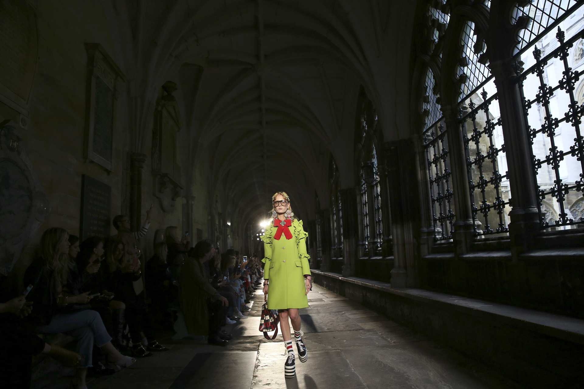 Models presents creations by Gucci at a catwalk show in the cloisters of Westminster Abbey in London