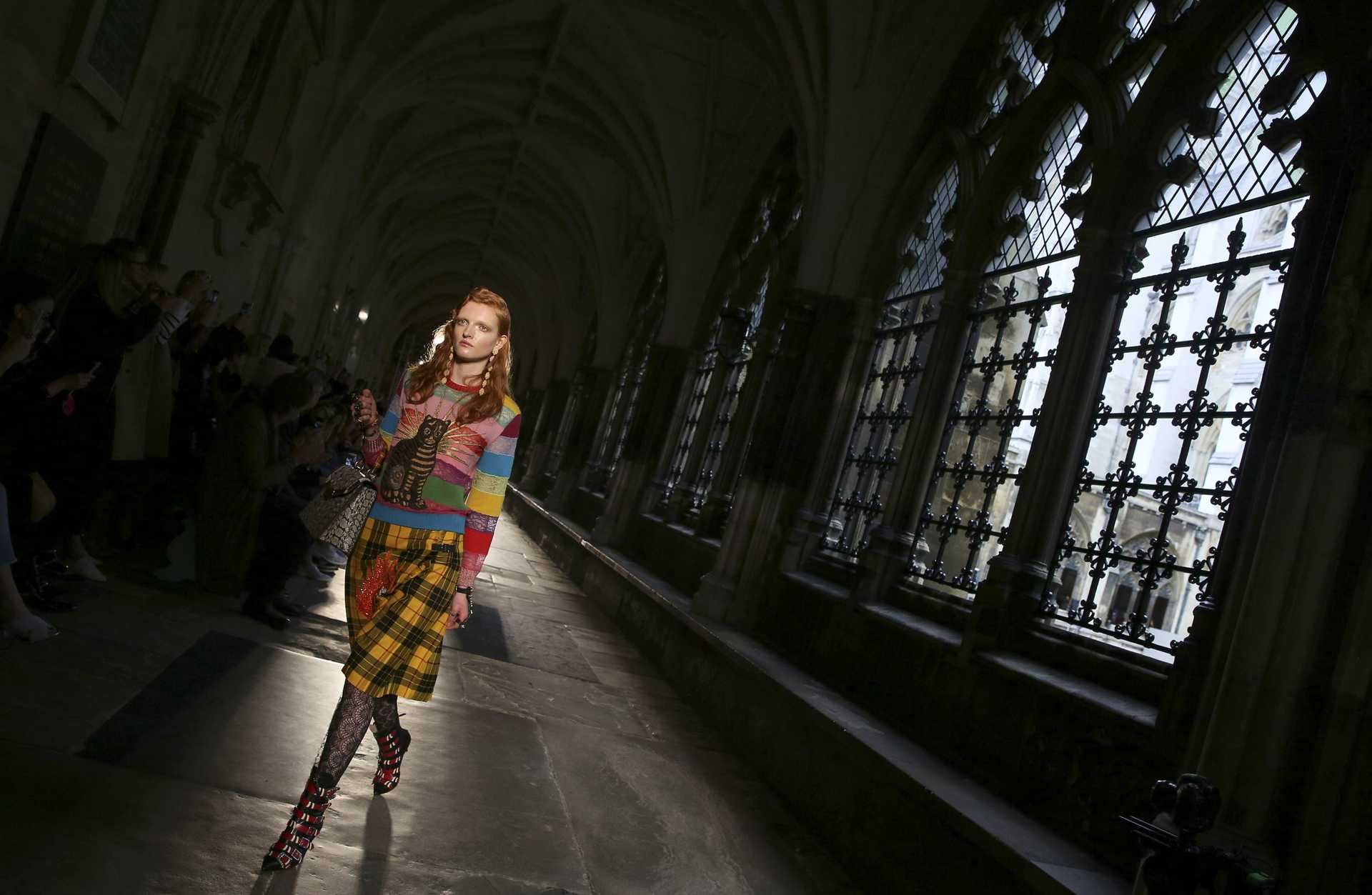 A model present a creation by Gucci at a catwalk show in the cloisters of Westminster Abbey in London