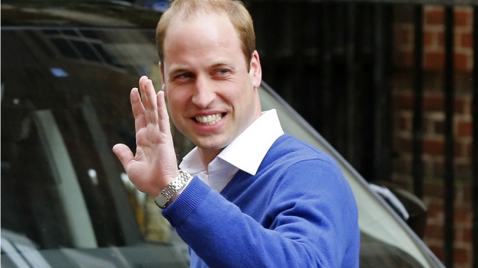 Britain’s Prince William waves as he leaves after the birth of his daughter at the Lindo Wing of St Mary’s Hospital, in London