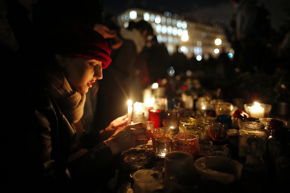 People gather on the Place de la Republique square to pay tribute to the victims of last year’s shooting at the French satirical newspaper Charlie Hebdo in Paris