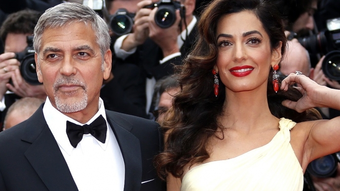 Cast member George Clooney and his wife Amal pose on the red carpet as they arrive for the screening of the film “Money Monster” out of competition during the 69th Cannes Film Festival in Cannes