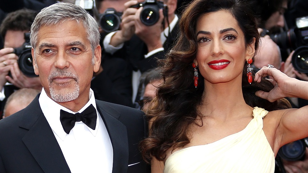Cast member George Clooney and his wife Amal pose on the red carpet as they arrive for the screening of the film 