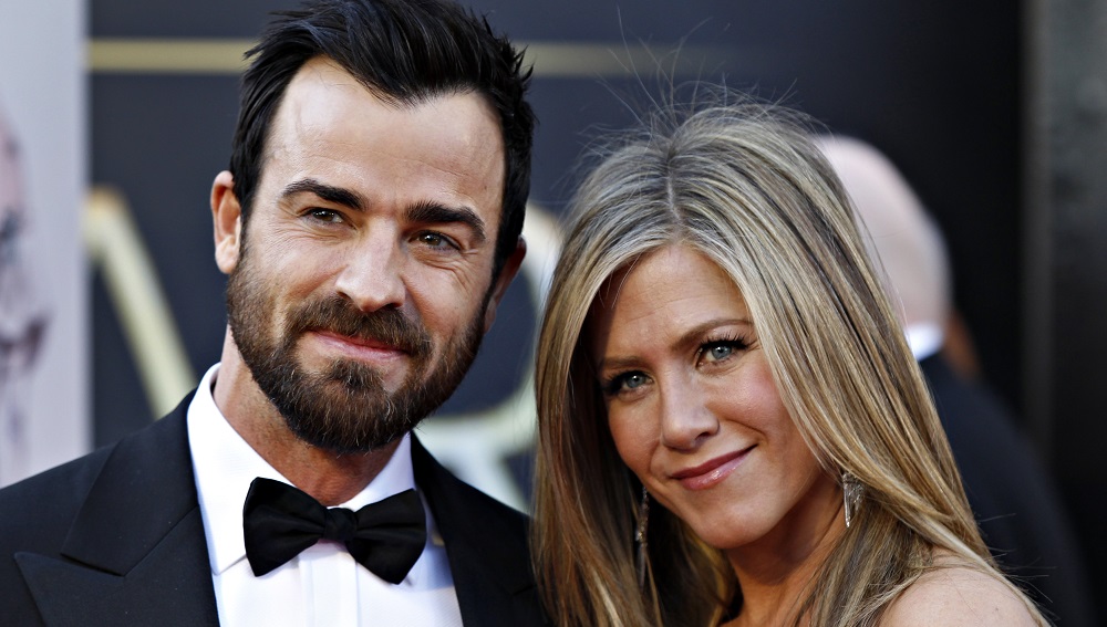 Actress Jennifer Aniston and her fiance Justin Theroux pose upon arrival at the 85th Academy Awards in Hollywood