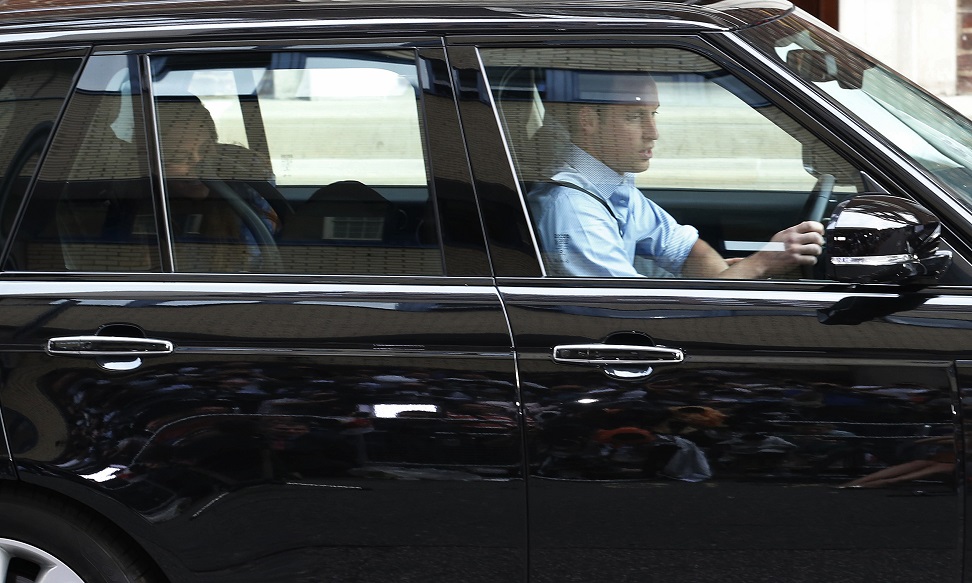 Britain’s Prince William, his wife Catherine, Duchess of Cambridge and their baby son drive away from hospital in London