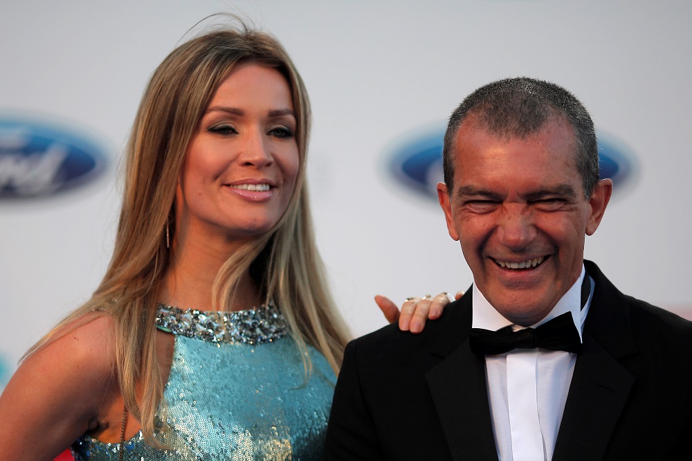 Banderas and his girlfriend Kimpel smile as they pose after their arrival at the Starlite Charity Gala in Marbella
