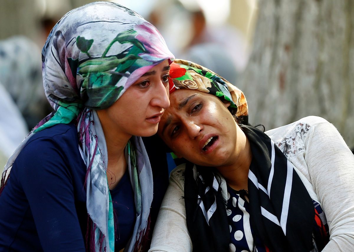 Women mourn as they wait in front of a hospital morgue in the Turkish city of Gaziantep, after a suspected bomber targeted a wedding celebration in the city, Turkey