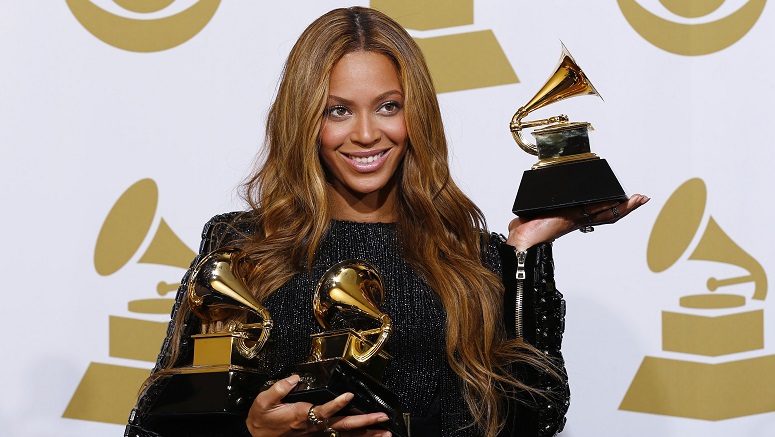 Beyonce holds the awards she won for Best R&B Performance and Best R&B Song for “Drunk in Love” and Best Surround Sound Album for “Beyonce” in the press room at the 57th annual Grammy Awards in Los Angeles
