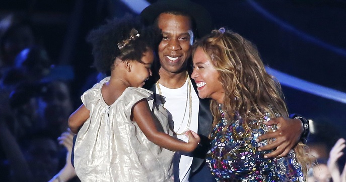 Beyonce smiles with Jay-Z and daughter Blue Ivy after accepting the Video Vanguard Award on stage during the 2014 MTV Video Music Awards in Inglewood