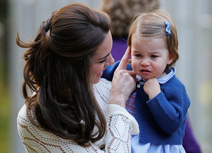 Britain’s Kate, Duchess of Cambridge, holds Princess Charlotte at a children’s party at Government House in Victoria