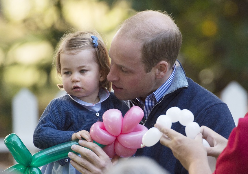 The Duke of Cambridge holds his daughter Princess Charlotte during a children’s party at Government House in Victoria