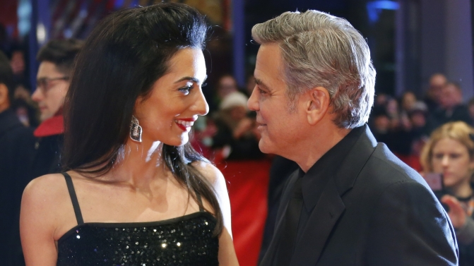 Cast member Clooney and his wife Amal arrive on red carpet for screening at opening gala of 66th Berlinale International Film Festival in Berlin
