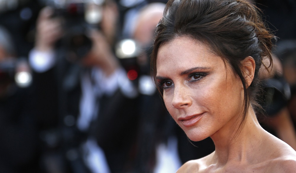 Fashion designer, model and singer Victoria Beckham poses on the red carpet as she arrives for the opening ceremony and the screening of the film 