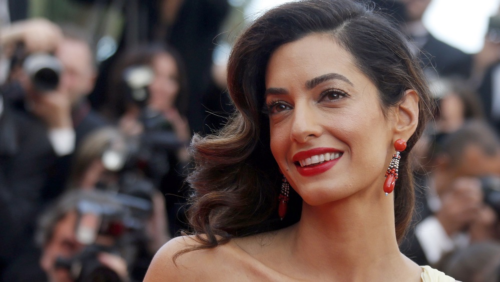 George Clooney's wife Amal poses on the red carpet as she arrives for the screening of the film 