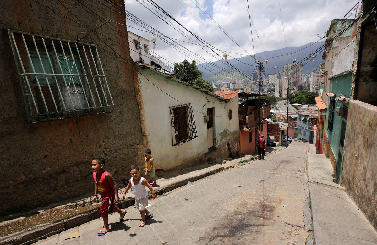 Children walk along a street in neighbourhood of San Agustin in Caracas