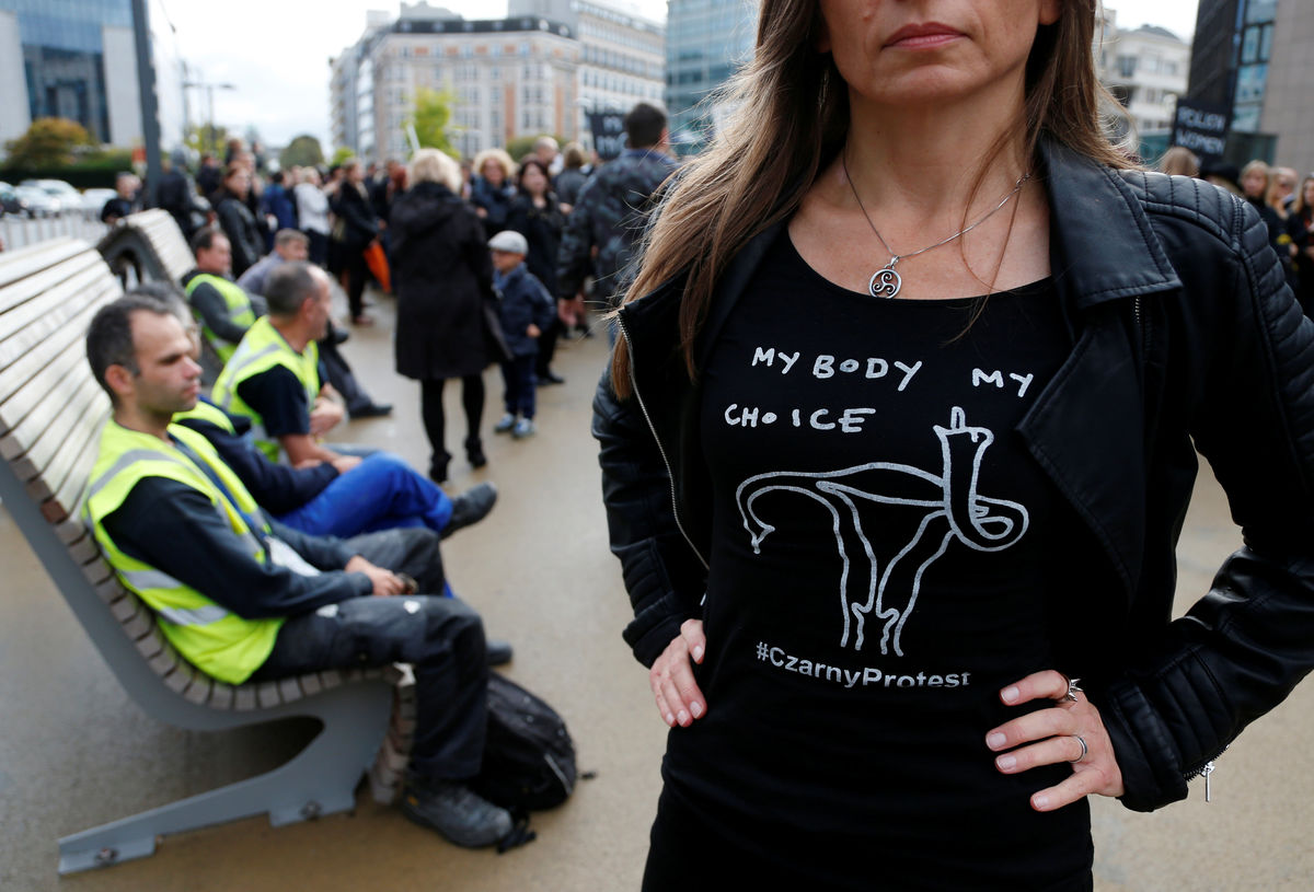 A demonstrator wears a shirt to protest against a proposed parliament bill to completely ban abortion in Poland, in front of EU institutions in Brussels