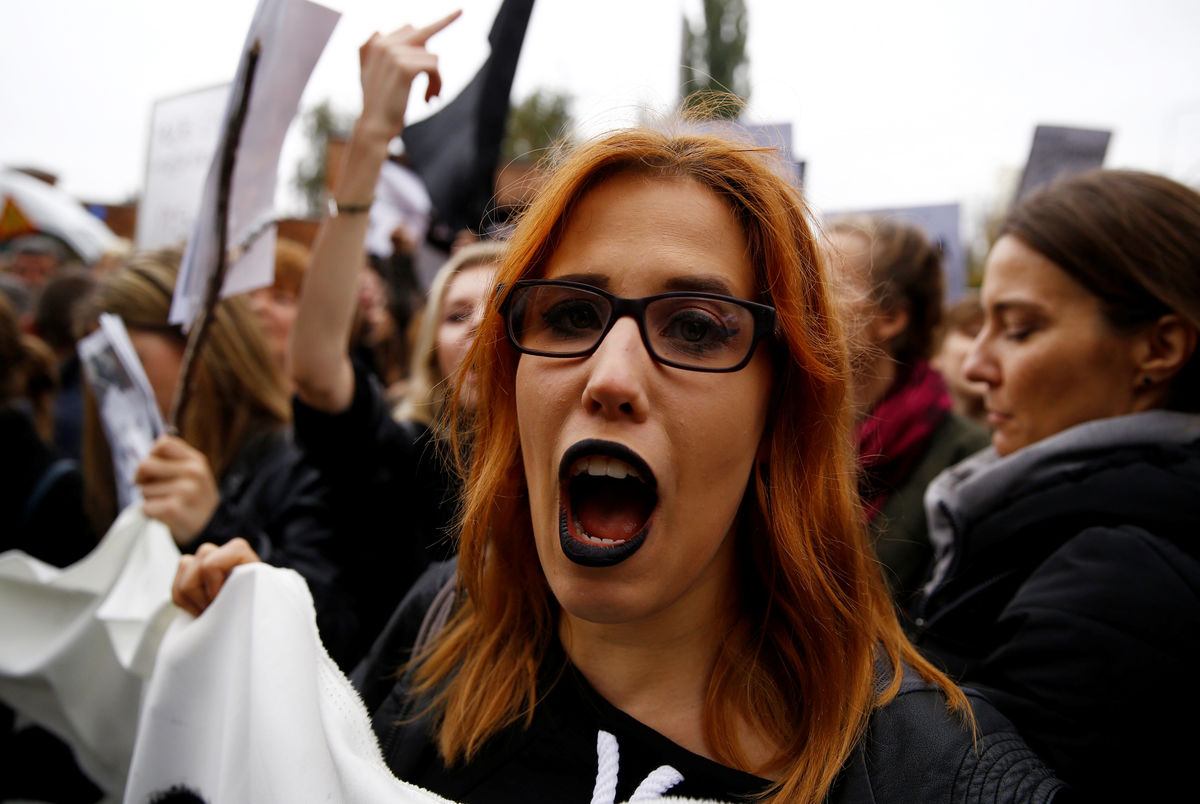 A woman shouts slogans as people gather in an abortion rights campaigners’ demonstration to protest against plans for a total ban on abortion in front of the ruling party Law and Justice (PiS) headquarters in Warsaw